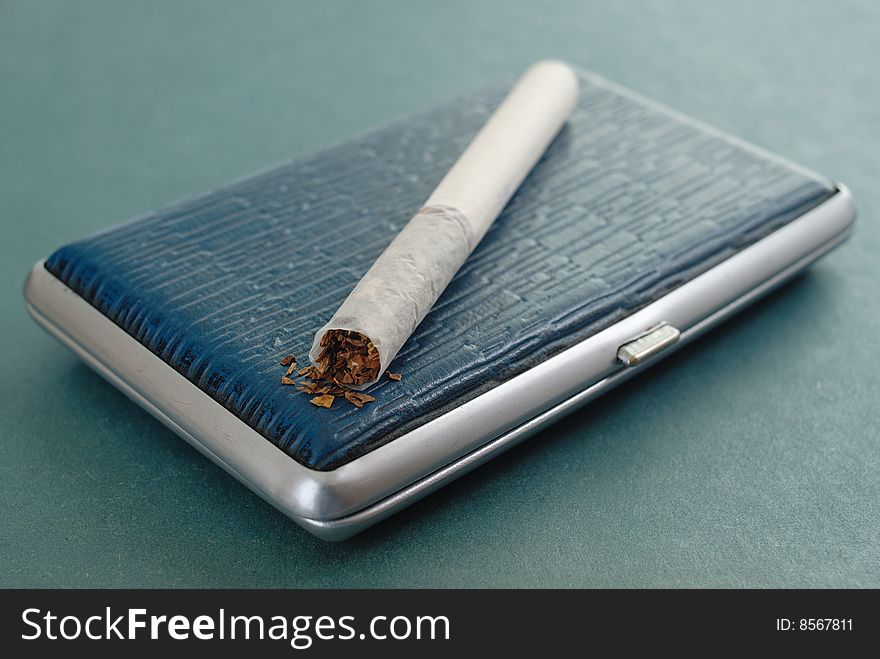 The russian cigarette lying on a leather cigarette-case