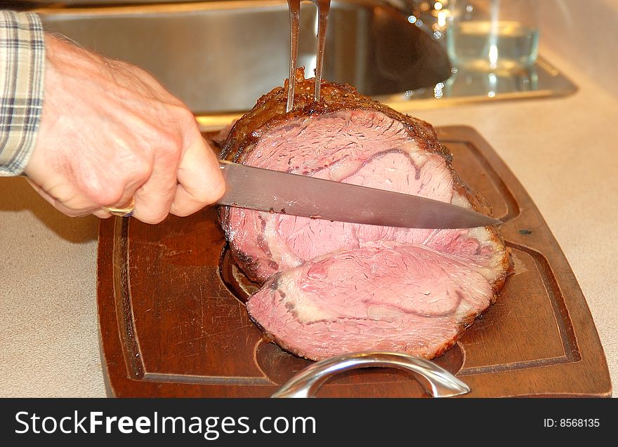 An image of a cooked roast beef being carved. An image of a cooked roast beef being carved.