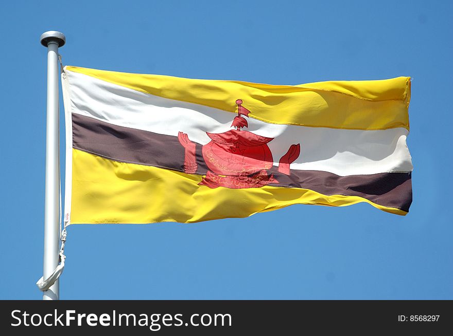 Flag of Brunei against blue sky
