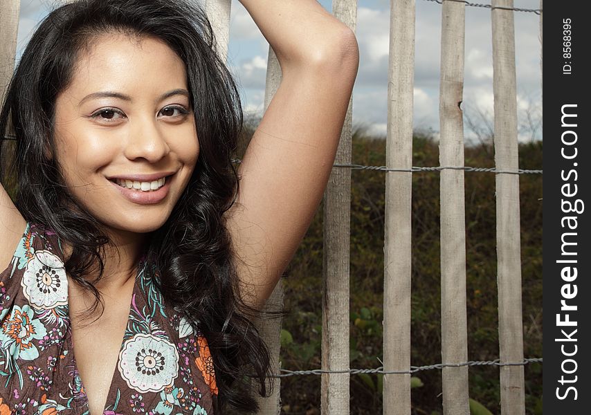 Woman smiling with a picket fence in the background