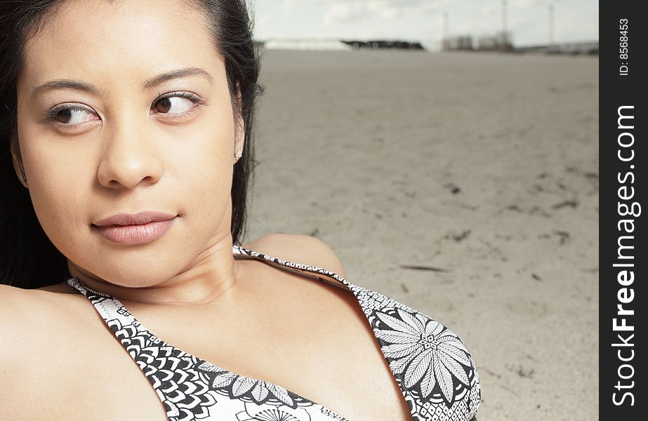 Young woman at the beach glancing away. Young woman at the beach glancing away