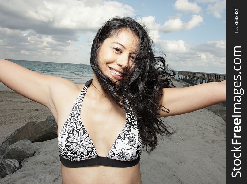 Beautiful young woman smiling with her arms extended outward