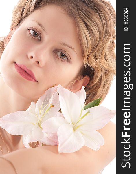 Portrait of attractive blond girl with white lily over white background