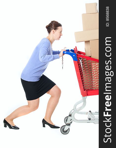 A woman pushing a heavily loaded cart. A woman pushing a heavily loaded cart