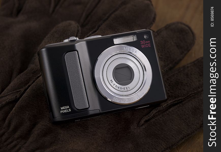 Point & Shoot Digital Camera on leather gloves