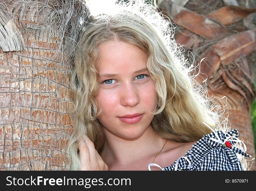 Pretty blond freckled girl at the palm tree. Pretty blond freckled girl at the palm tree.