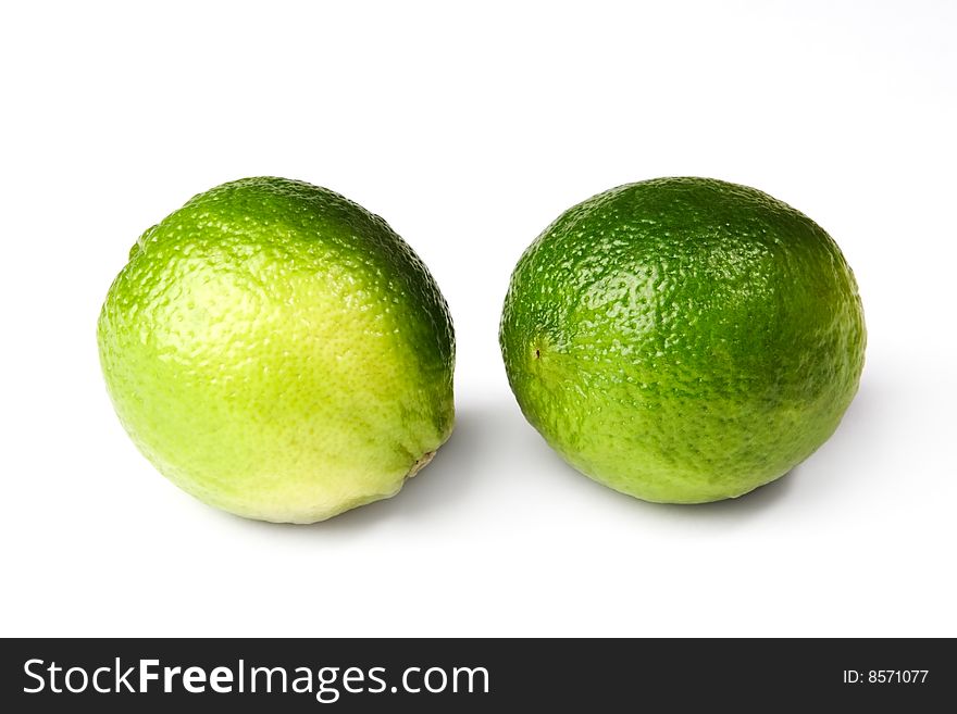 Two fresh lime fruit isolated on white background