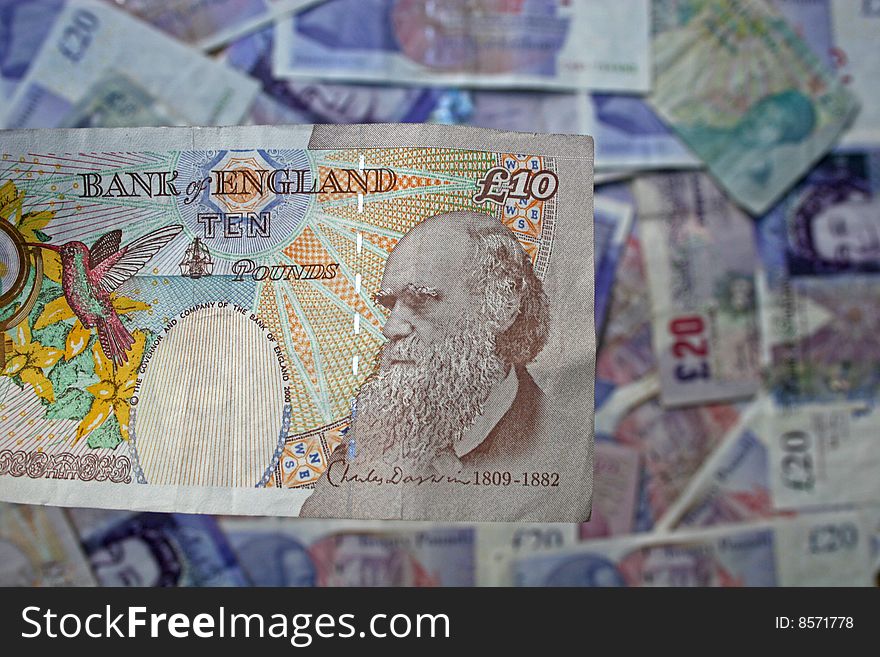 Ten pound note over background of other notes