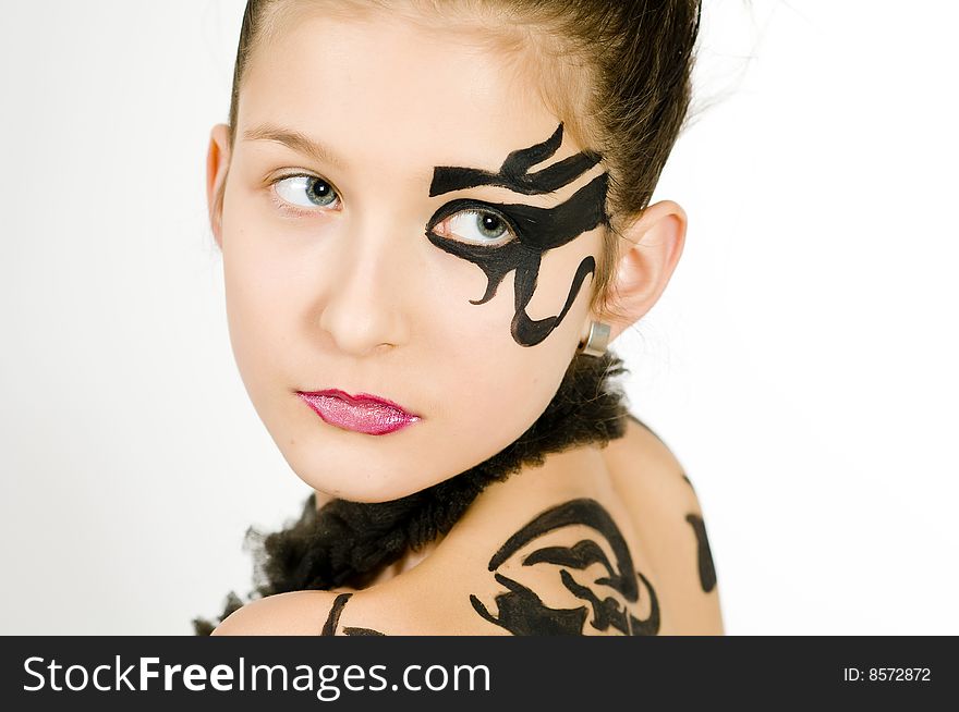 Closeup of girl with black scorpio sign painted on back and face. Closeup of girl with black scorpio sign painted on back and face