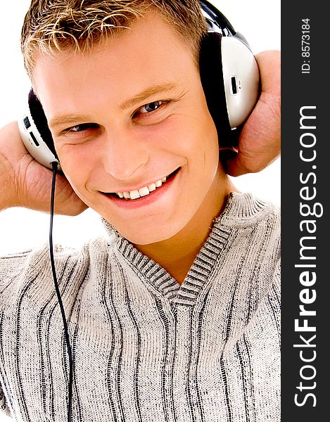 Smiling handsome male listening to music on an isolated background