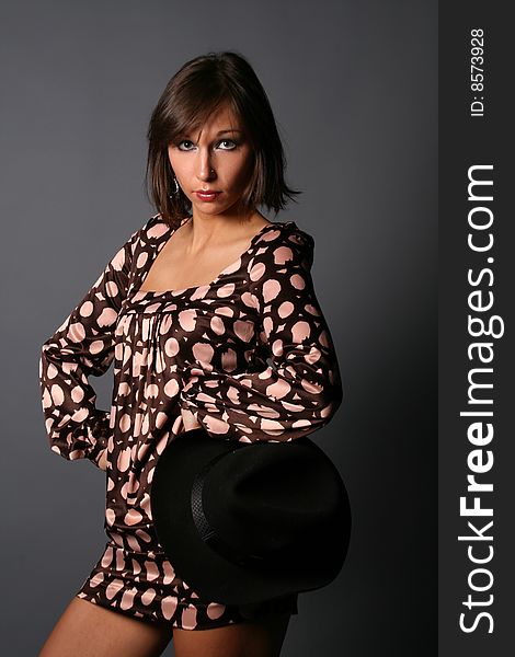 Woman with a hat posing in studio