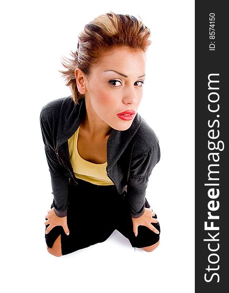 High angle view of sitting woman looking at camera on an isolated white background