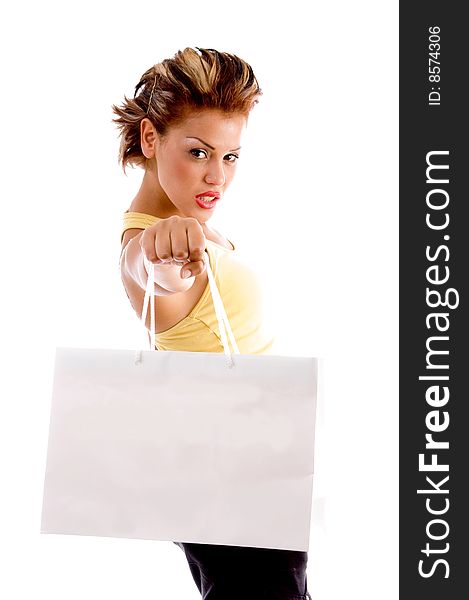 Standing woman showing shopping bag with white background