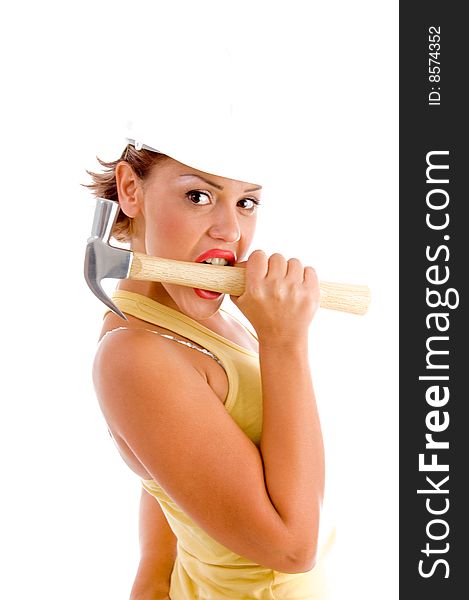 Side view of woman holding hammer with mouth on white background