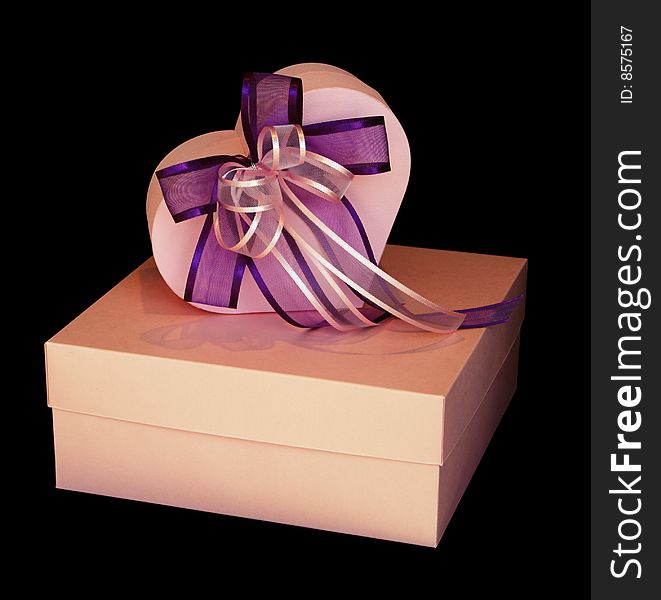 Gift boxes and ribbon isolated on black. Gift boxes and ribbon isolated on black.