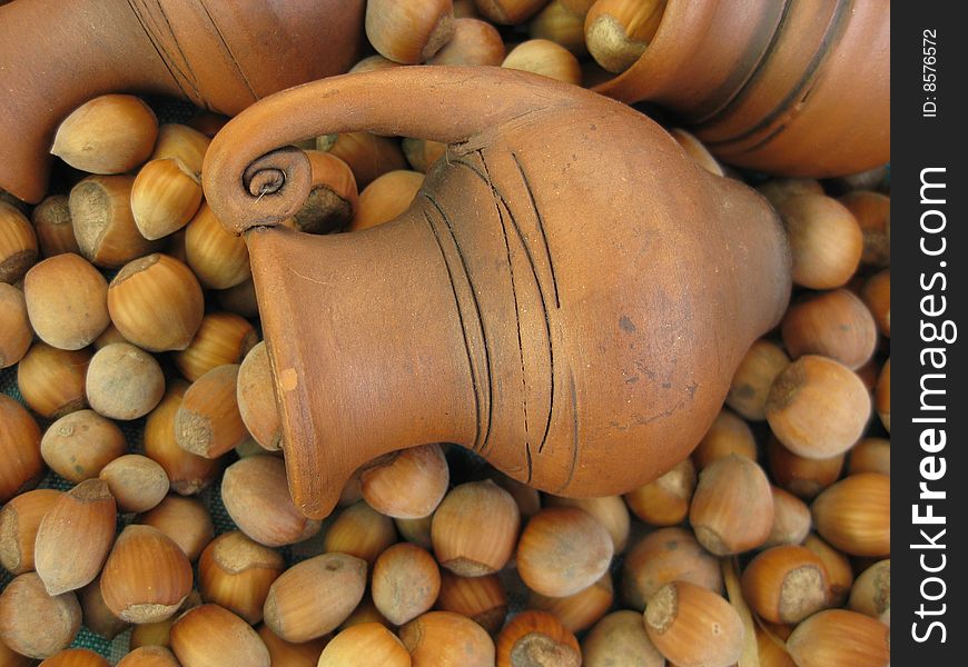 Old crock on background of nuts. Old crock on background of nuts