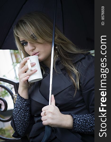 Girl with umbrella drink tea at autumn park. Girl with umbrella drink tea at autumn park.