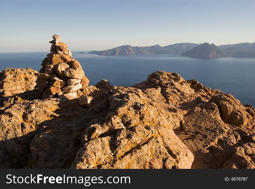 Rock pile on reef on Corsica seashore