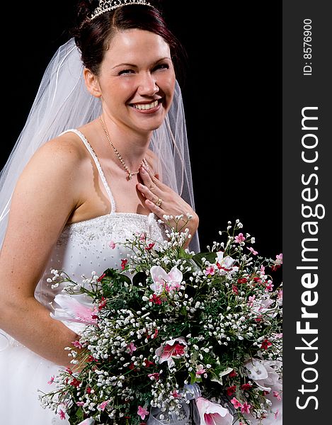 White Bride at her wedding posing with veil