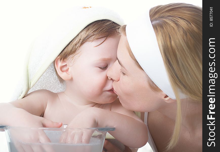 Young mum kisses the child of the boy. Young mum kisses the child of the boy