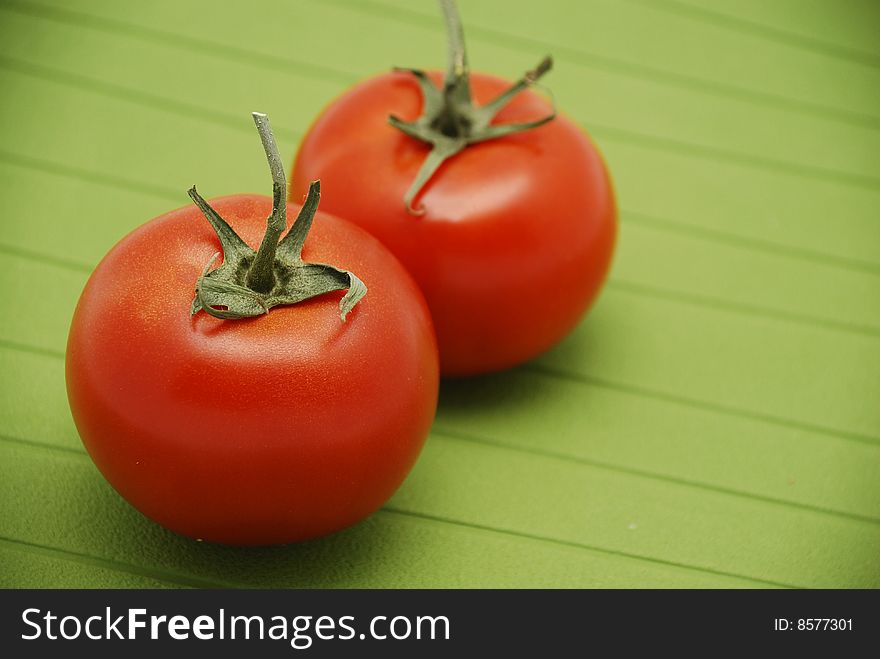 Fresh Tomatoes On Green Background