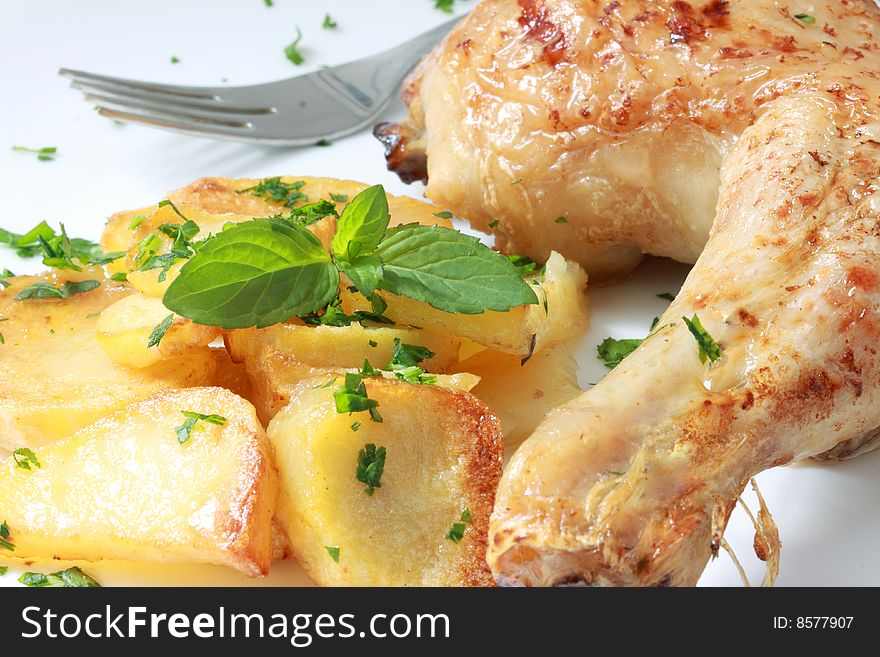 Grilled chicken leg with potato and parsley