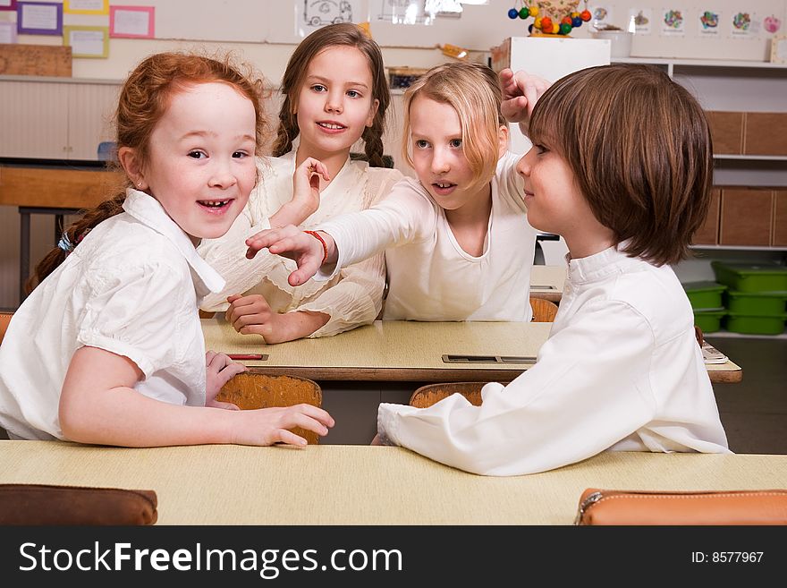 Group of little students with different ages in a classroom. Group of little students with different ages in a classroom