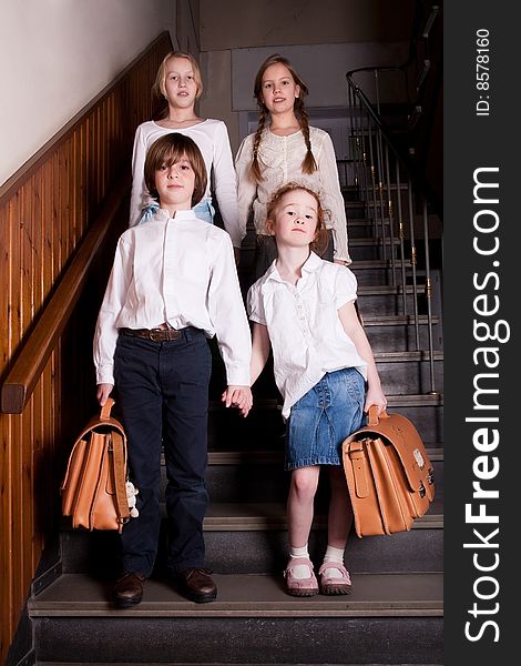 Group of little students with different ageson the stairs. Group of little students with different ageson the stairs
