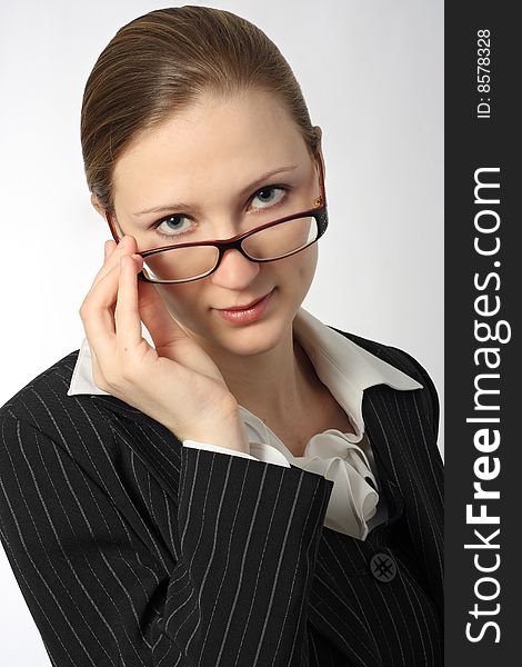 Young beautiful businesswoman with glasses on white background