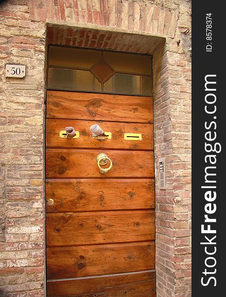 Wooden entrance door with brass doorknob and post boxes. Wooden entrance door with brass doorknob and post boxes