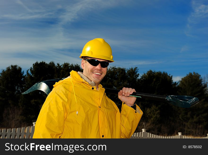 Portrait of the man in uniform with a shovel close up