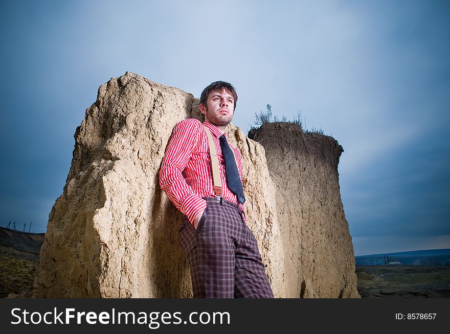 Stylish man outdoors over blue sky background