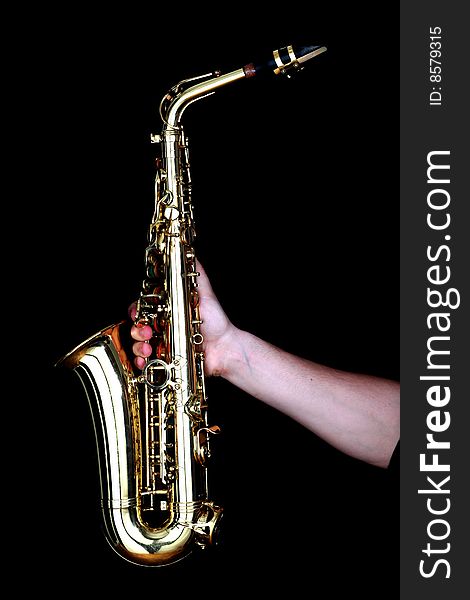 Golden alto saxophone in hands of young man