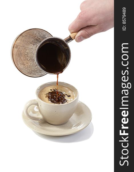 Coffee poured from coffee maker in cup on a white background