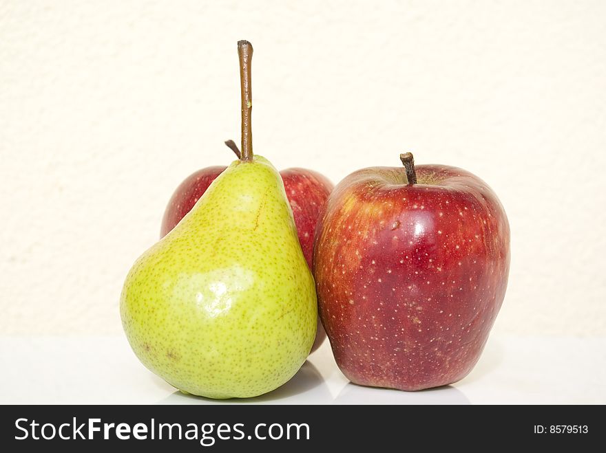 Reds apple and green pear on white background. Reds apple and green pear on white background