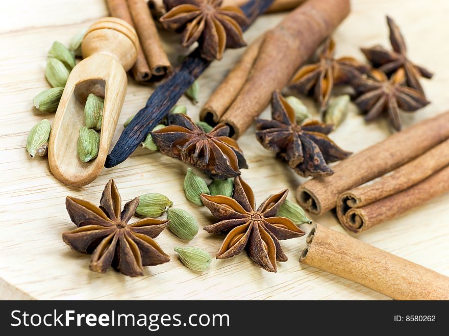 Cinnamon Sticks,Cardamom,vanilla bean and star anise on white - tight depth of field