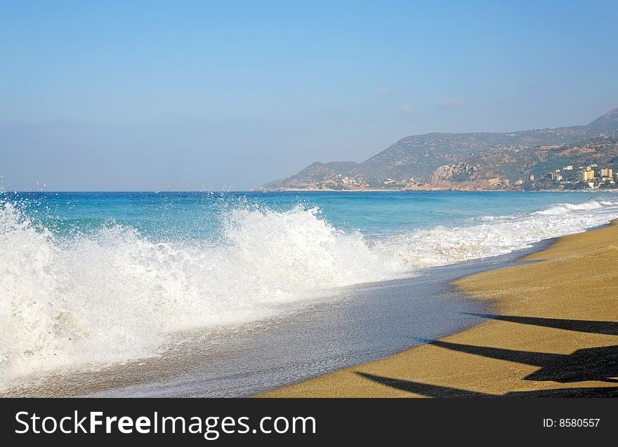 Scene of sky, sea, waves and sandy beach.