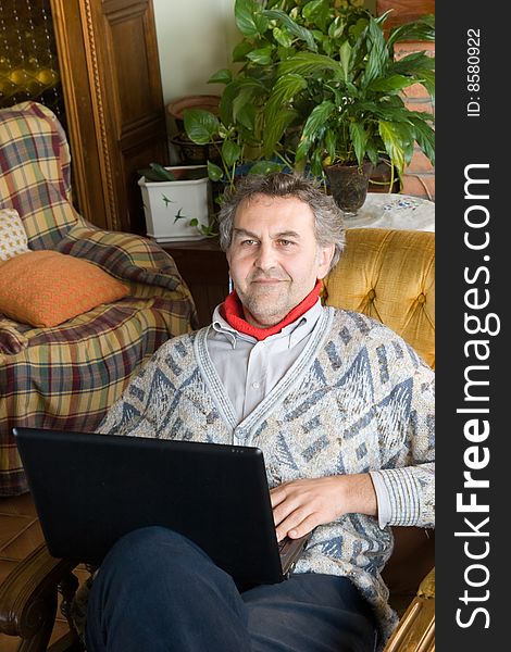 An mid age man at work with his computer at home