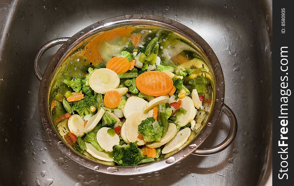 Close-up of fresh vegetables in silver strainer