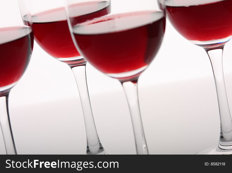 Glasses of red wine over white background. Glasses of red wine over white background.