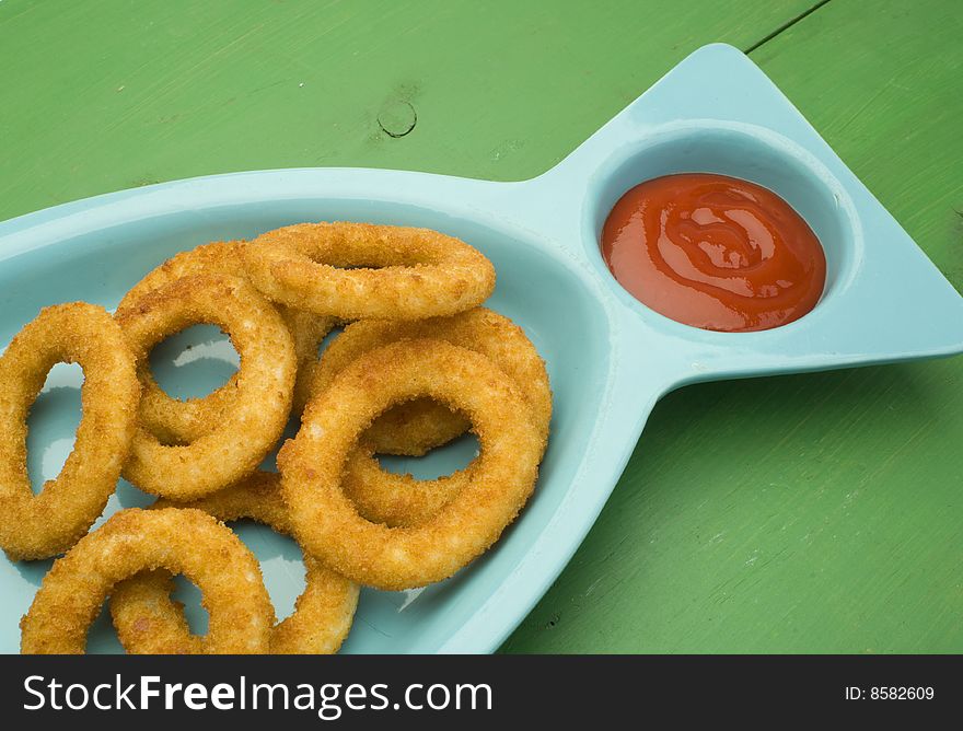 An order of onion rings with ketchup