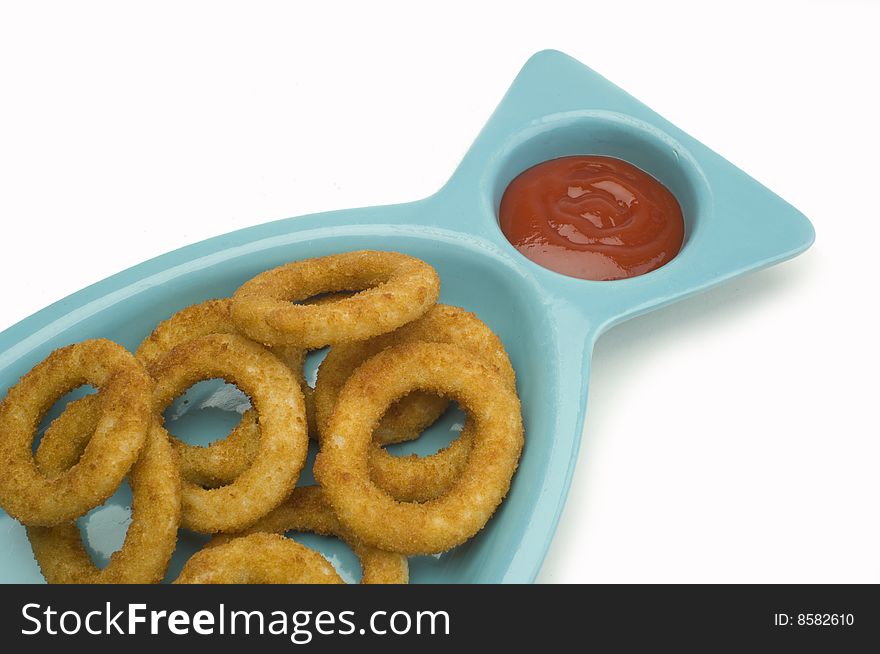 An order of onion rings with ketchup on white