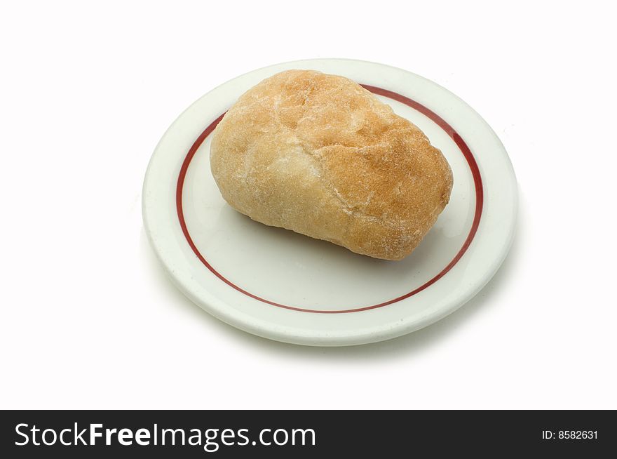 A dinner roll on a white plate
