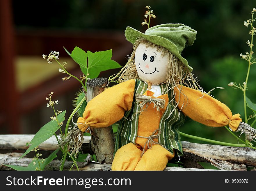 Gardening theme: rag doll on a garden fence. Gardening theme: rag doll on a garden fence.