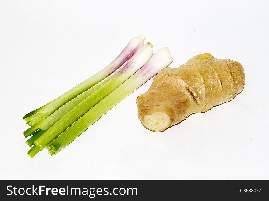 Some onions and ginger over white background.