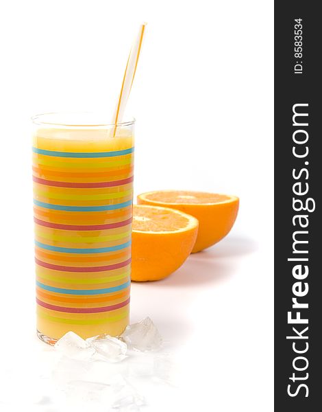 Oranges, ice and juice in glass on white