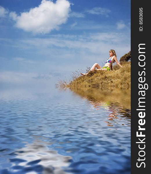 Girl sits on a grass and looks in the sky. Girl sits on a grass and looks in the sky