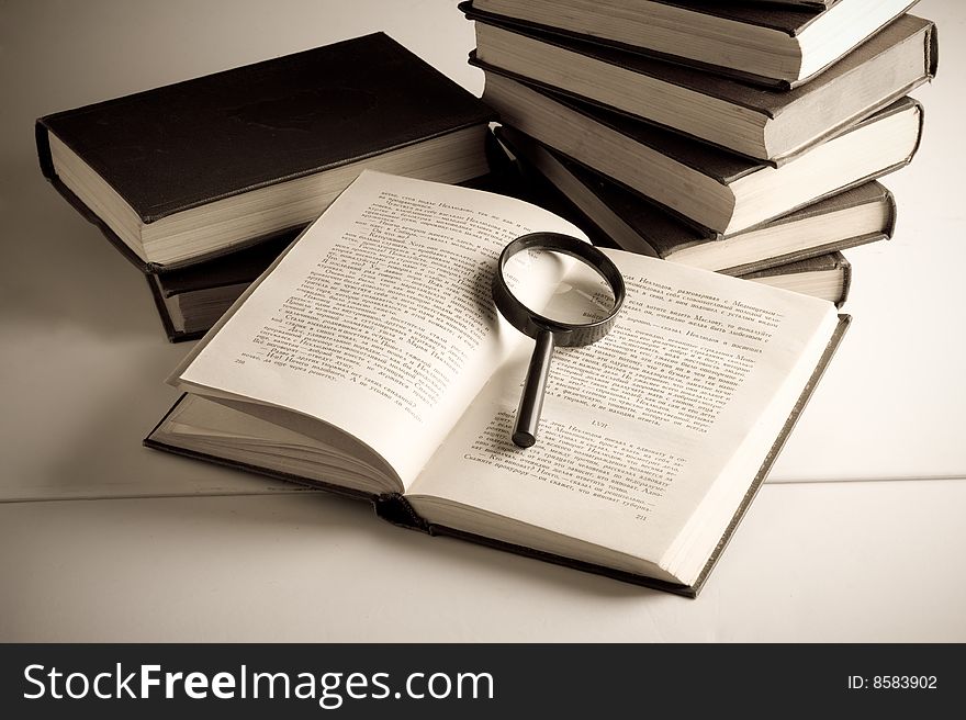 Books on the table. Isolated over black background