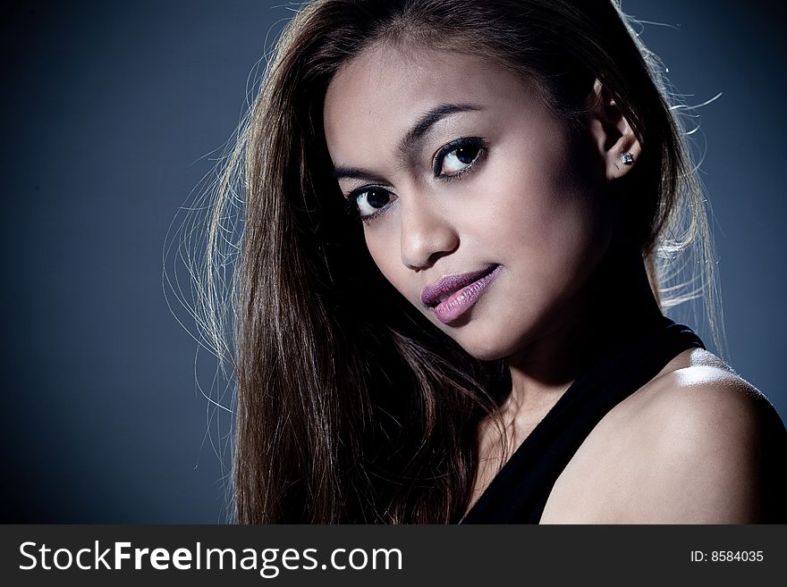 Portrait of mysterious young woman smile with dark background. Portrait of mysterious young woman smile with dark background