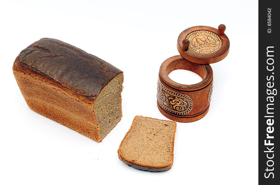 Loaf of bread and saltcellar on the white background